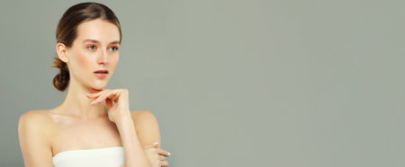 Happy beautiful woman holding her cheeks a laugh looking to the side. Close up.の写真素材