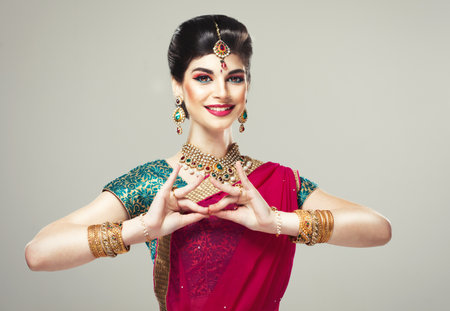 Young model dressed in posh, gildet, Indian costume. Traditional Indian costume.の写真素材