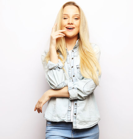attractive caucasian smiling young woman blond over white backgroundの写真素材