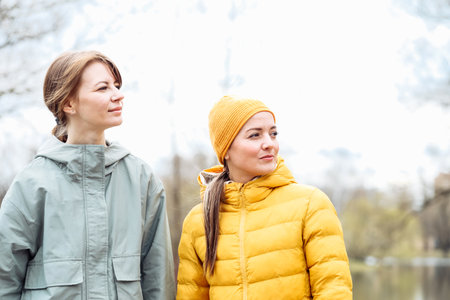Two young athletic women friends in a spring park.の写真素材