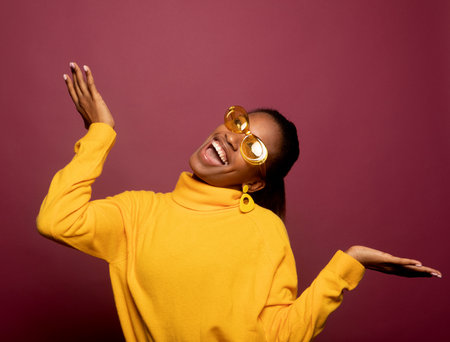 Pretty young woman dancing isolated pink color background.