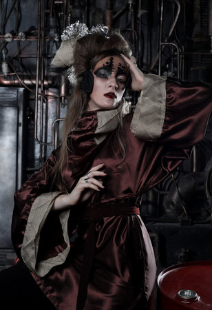 Steampunk woman with bright make up in a creative interior. Art and fashion concept.の写真素材