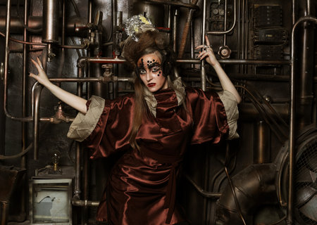 Steampunk woman with bright make up in a creative interior. Art and fashion concept.の写真素材