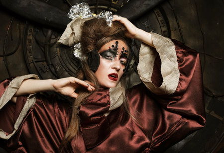 Steampunk woman with bright make up in a creative interior. Art and fashion concept.の写真素材