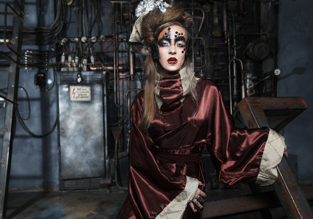 Steampunk woman with bright make up in a creative interior. Art and fashion concept.の写真素材