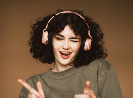 lifestyle and people concept: young woman in headphones listening to music smiling and dancing.の写真素材