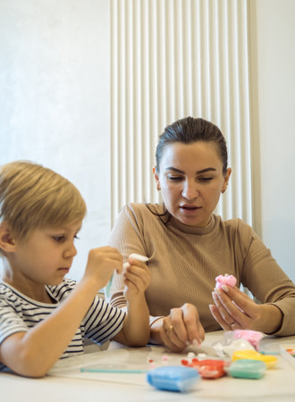 A woman and her six-year-old son make figures out of plasticine.