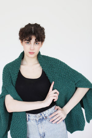 Fashion female model with curly hair posing in studio over white background.の写真素材