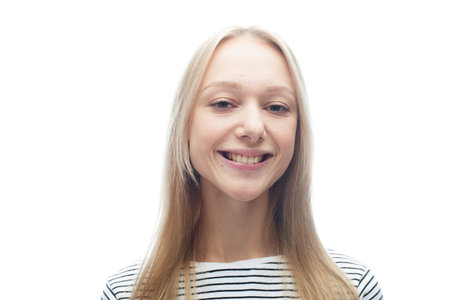 Young smiling blond woman over white background.