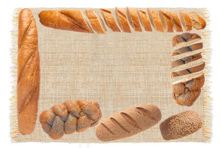 Fresh breads and sliced fresh breads on sackcloth isolated on white background.  Breads viewed from above. Top view with space for your textの写真素材
