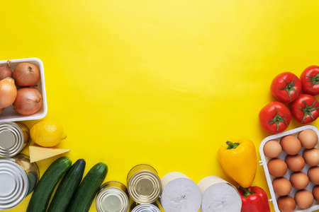 Food donations on yellow background. Food help . Top view with copy spaceの写真素材