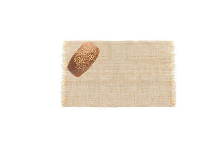 Fresh bread on sackcloth isolated on white background.  Bread viewed from above. Top view with space...