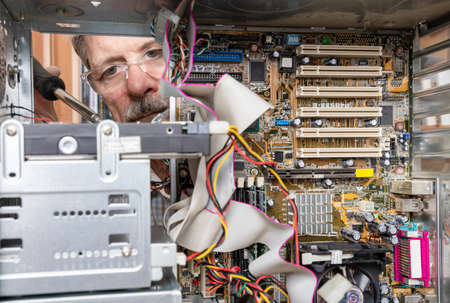 Repairing and assembling a desktop computer. Professional man repairing and assembling a desktop...