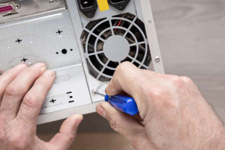 Repairing and assembling a desktop computer. Professional man repairing and assembling a  power...