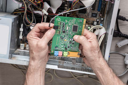 Repairing and assembling a desktop computer. Professional man repairing and assembling a desktop...