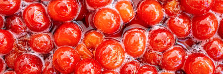 Homemade cherry jam. Cooking sweet merry jam. Side view. Banner.  Closeup