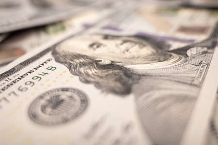 Pile of dollars lies on the table. One hundred dollar bills dumps on table. Background for design...