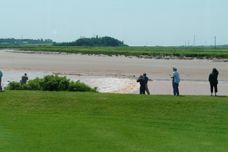 Tidal Bore rushing in as people gather to watch , Novia Scotia, Canadaの写真素材