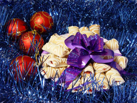 cookies with violet bow and red balls on the blue tinselの写真素材