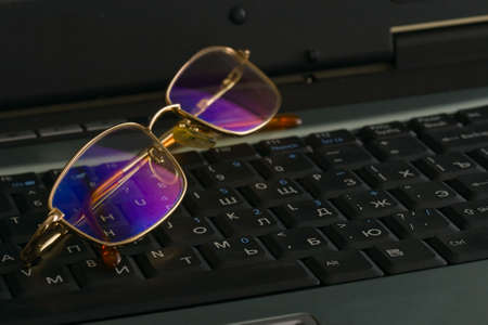 laptop and laying on glasses