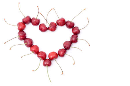 red shape heart from sweet cherry with white background, left handed position, copy space for the textの写真素材