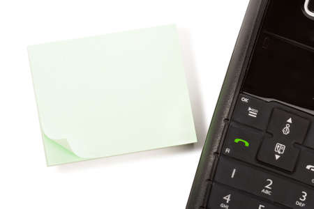 blank stick note page with black dect phone handsetの写真素材