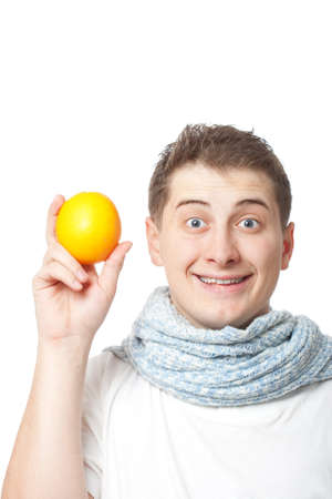 young adult man holding orange, white backgroundの写真素材