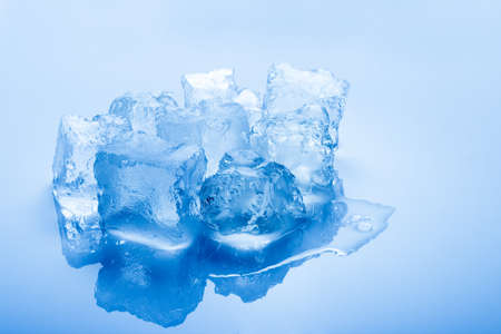 isolated blue toned cold ice cubesの写真素材