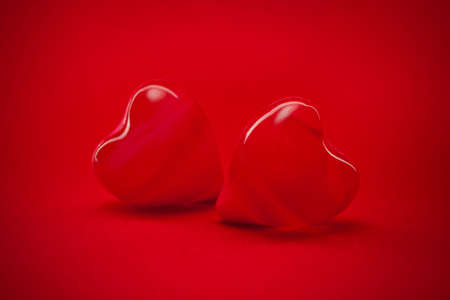 two red hearts on red background wallpaper