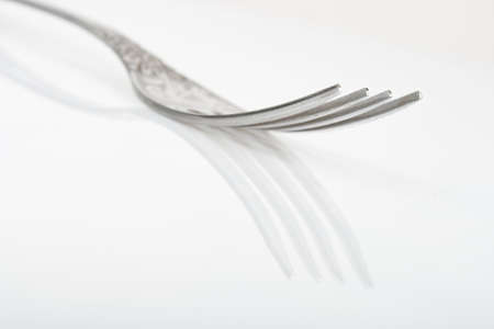 metal fork on white background with reflectionの写真素材