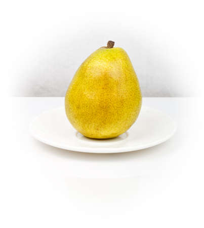 isolated yellow pear on the white plateの写真素材