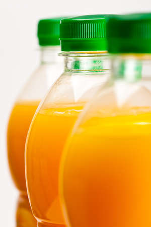orange juice three bottles background vertical