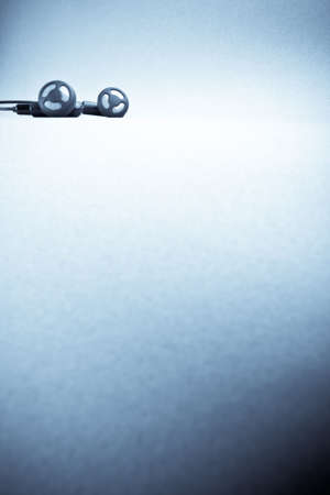 blue background woith headphones, copy space for the text