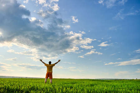 man in the field, rising handsの写真素材