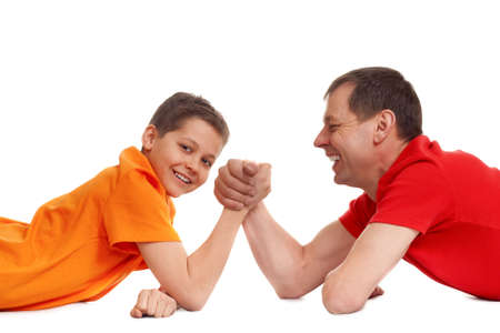 arm wrestling for father and son on whiteの写真素材