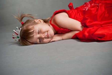 sleeping princess in red dressの写真素材