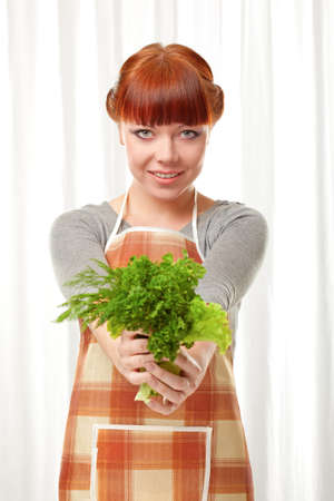 ginger woman wearing apron with greenery over whiteの写真素材