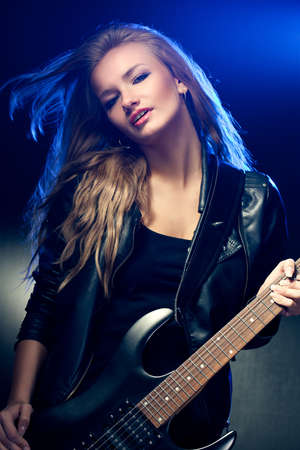 blonde woman rock star portrait with guitarの写真素材