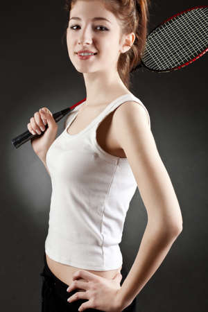 woman with badminton racket over dark backgroundの写真素材
