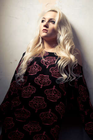blond woman portrait near wallの写真素材
