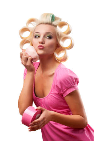 blonde woman with rollers on head over whiteの写真素材