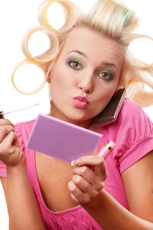 funny blonde woman with rollers on head over whiteの写真素材