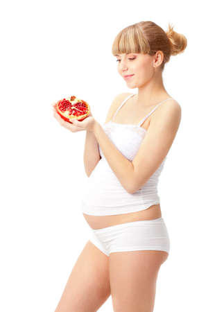 pregnant woman with red pomegranate over whiteの写真素材