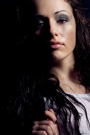 beautiful wet sexy woman portrait with dirty makeupの写真素材