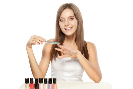 beautiful woman holding nail file over whiteの写真素材