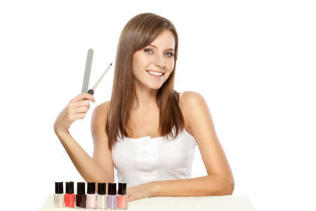 beautiful woman holding nail file over whiteの写真素材