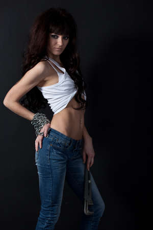 beautiful garage style weared woman portrait near black wallの写真素材