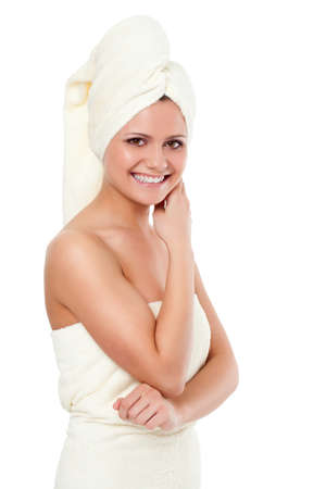 isolated standing woman wearing bath  towel over whiteの写真素材