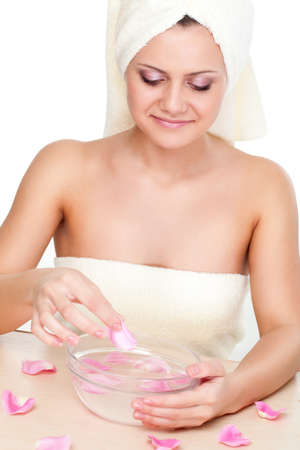 beautiful woman washing face over white backgroundの写真素材
