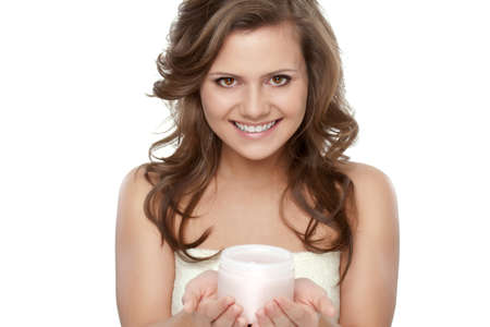 beautiful woman after bath holding jar with creamの写真素材